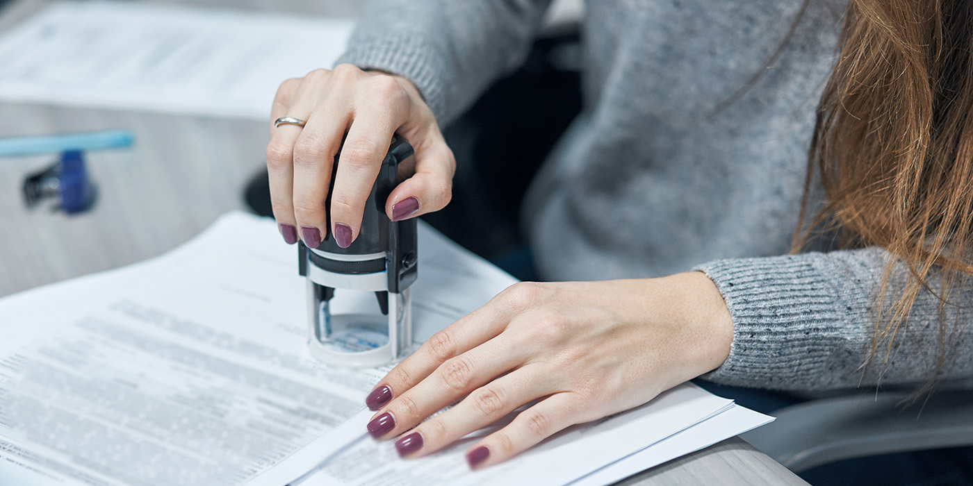 Lady's hand stamping a paper